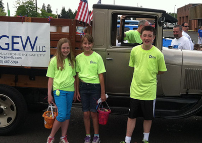 Katie and Michael Clarke handing out candy and safety stickers at Battle Ground parade with Clarke’s 1929 AA Ford