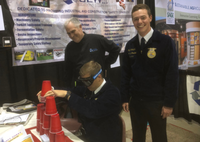 Demonstrating effects of impairment with "Drunk goggles" to FFA State officers.